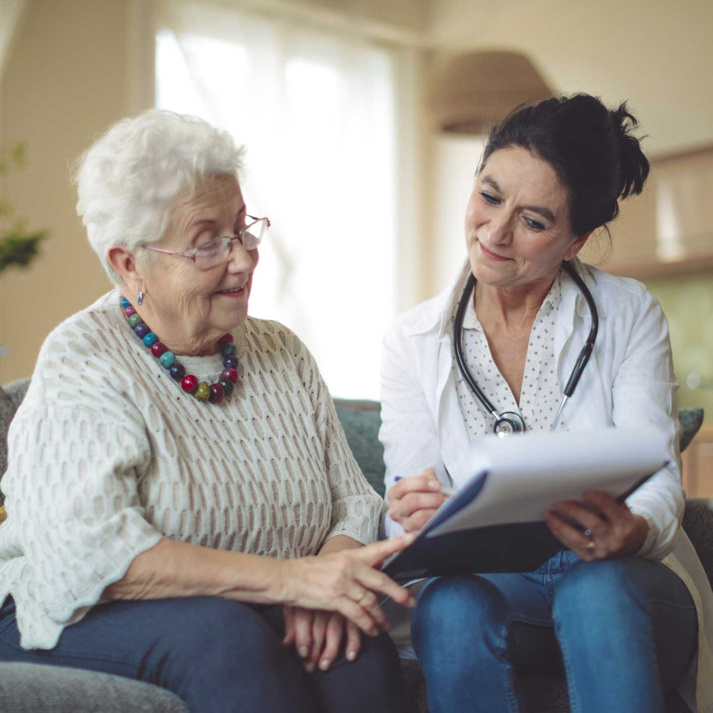 Caregiver explains paperwok to elder woman
